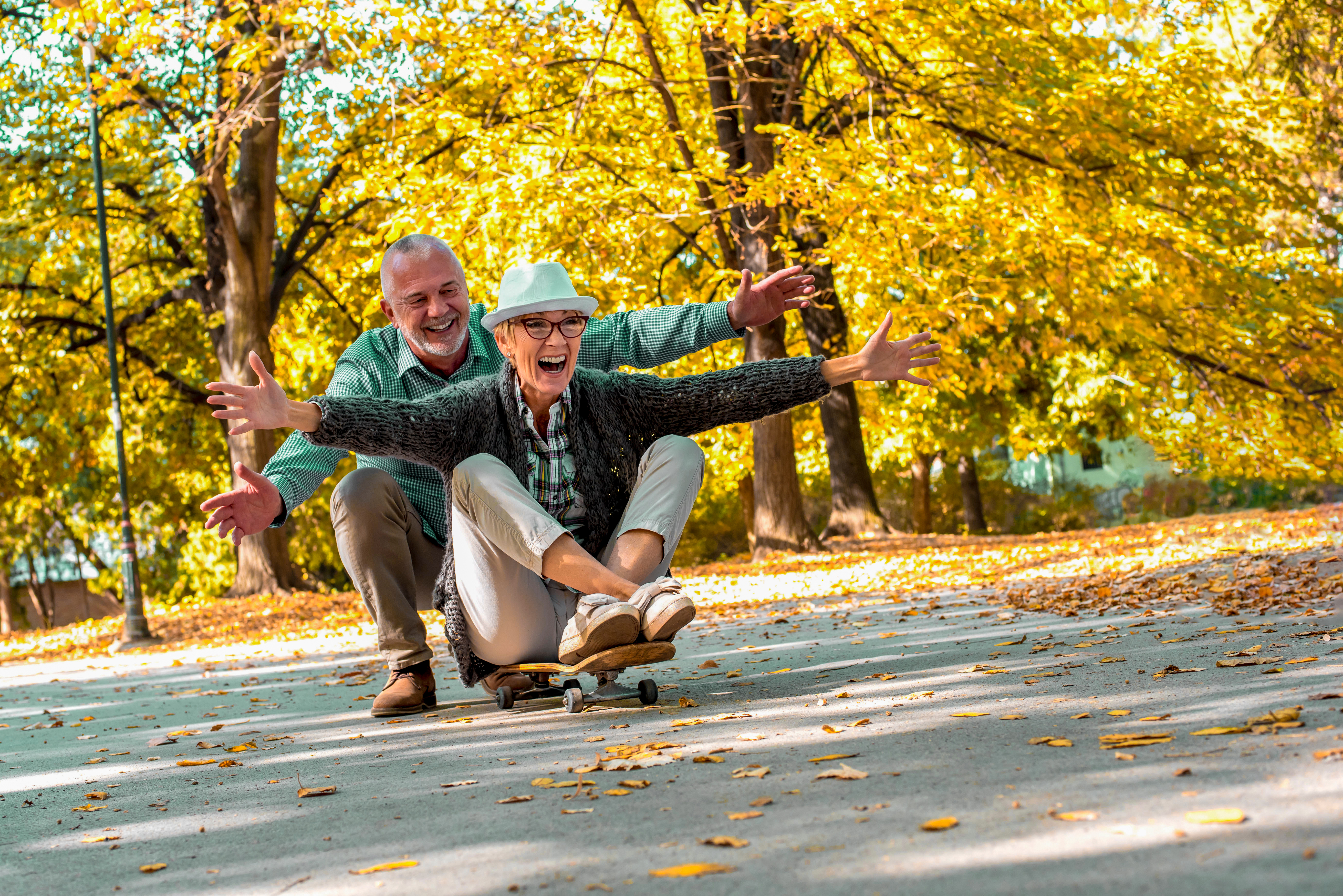 Couple happily enjoying nature with arms outstretched.